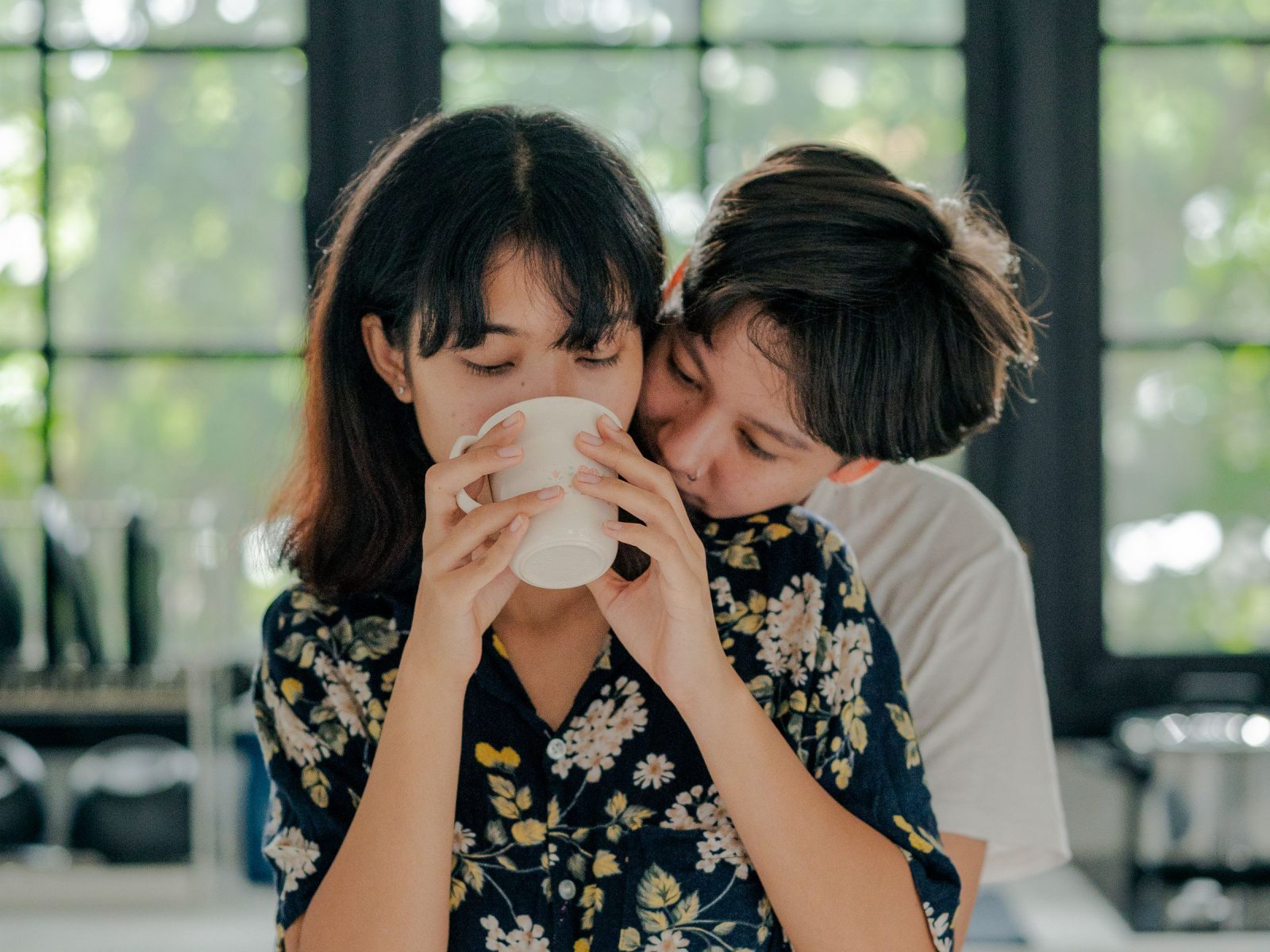 A couple sharing a coffee at the kitchen window